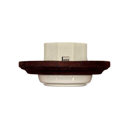 Single SCHUKO porcelain socket with dark wooden frame, white, flush-mounted, close-up detail
