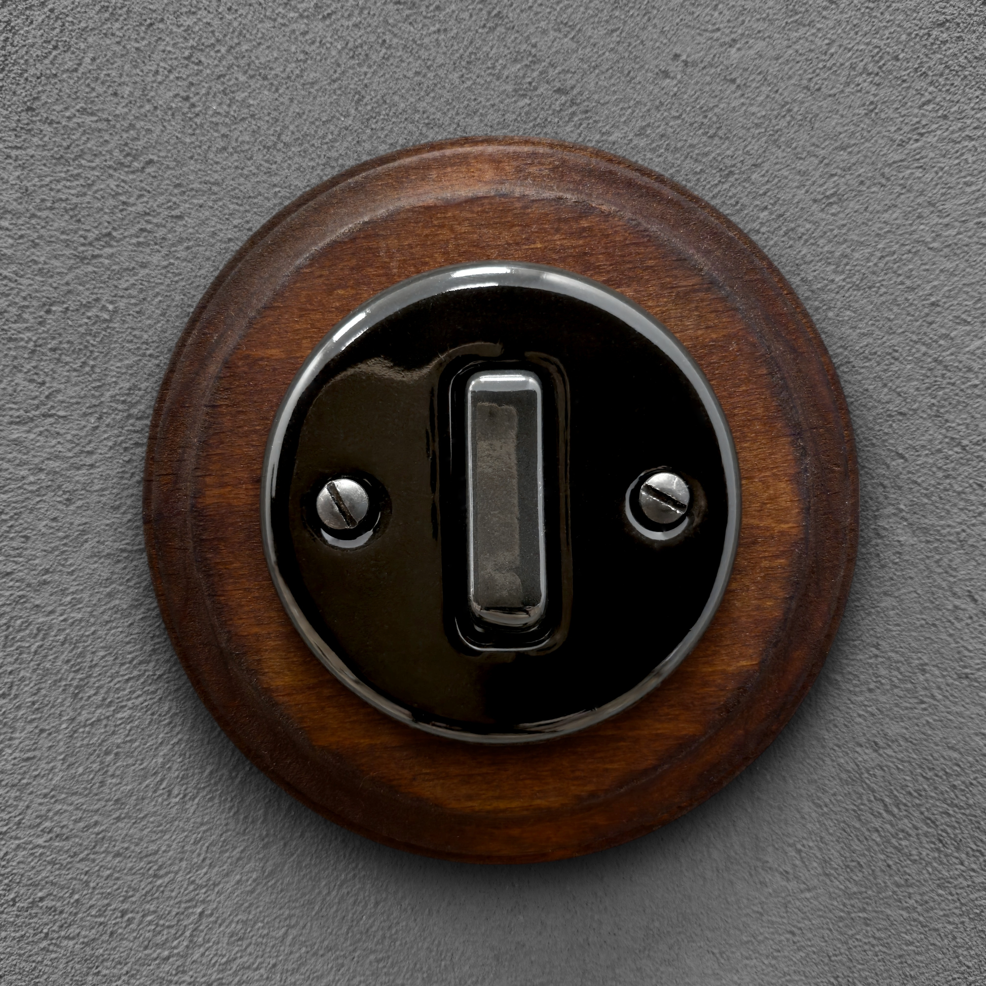 black porcelain 1gang2way light switch dark wood frame, flush-mount, front