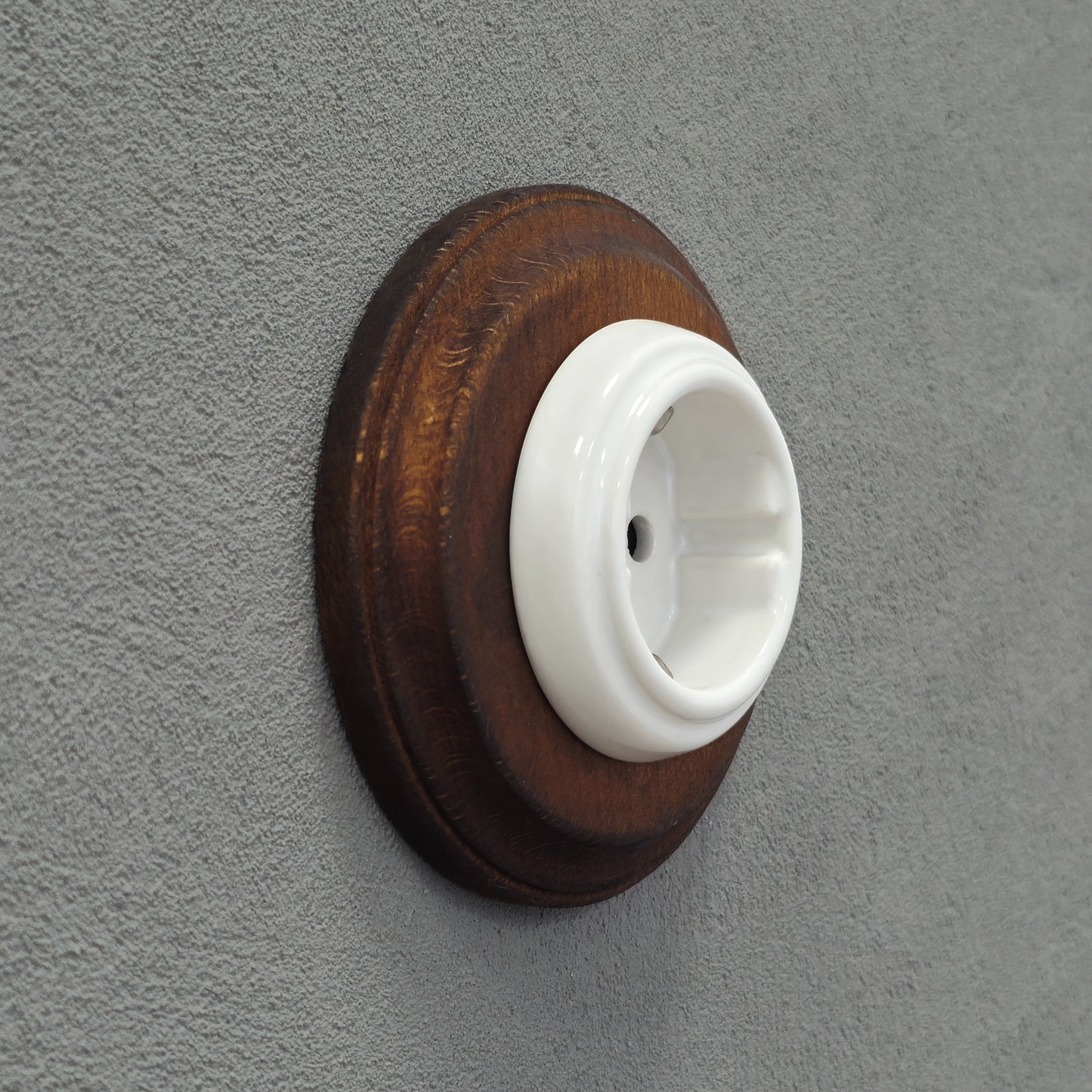 Single SCHUKO porcelain socket with dark wooden frame, white, flush-mounted, side view