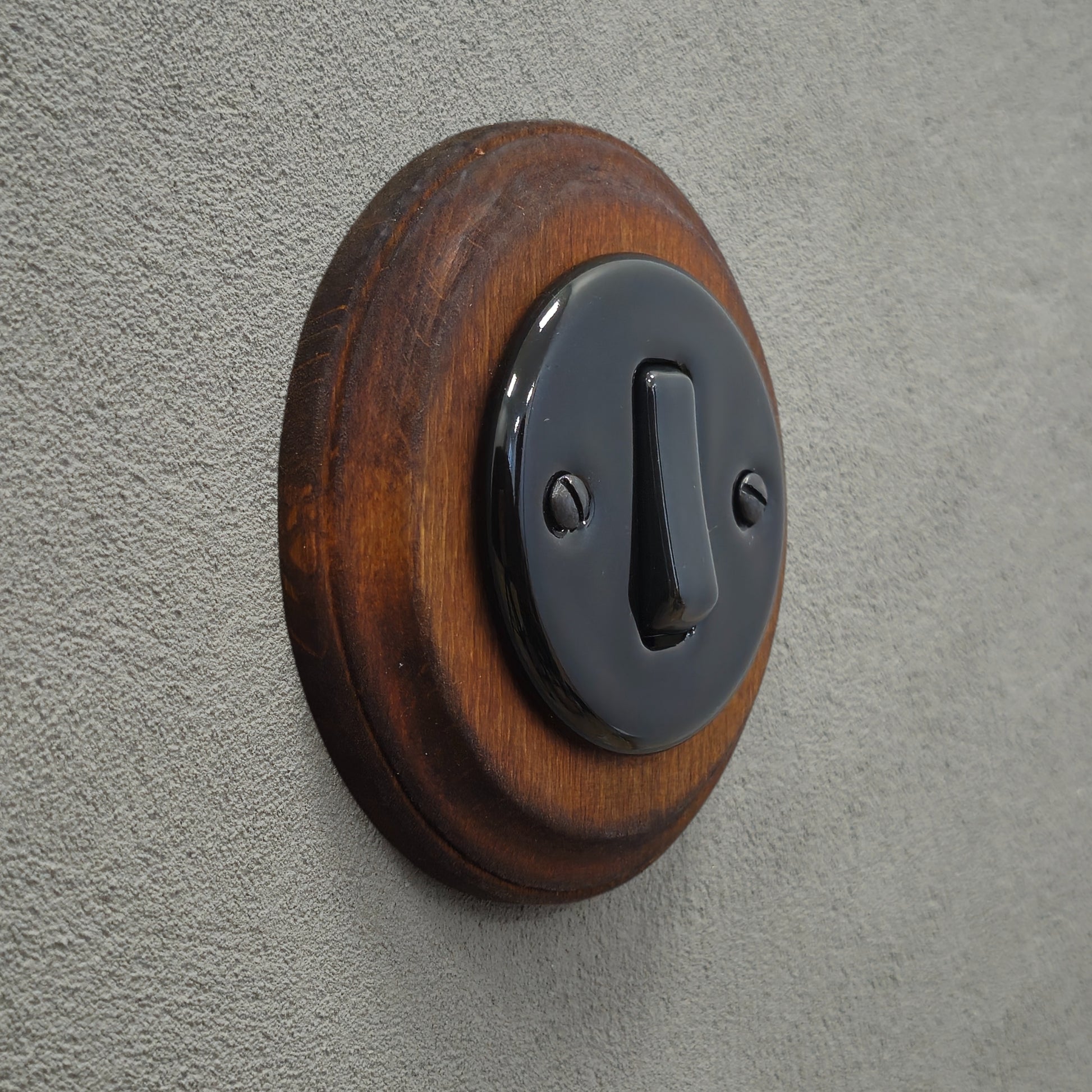 black porcelain 1gang2way light switch dark wood frame, flush-mount, angled