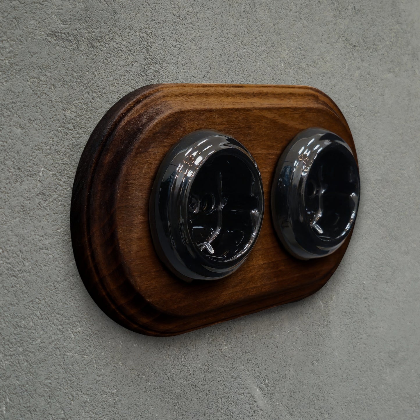 Double SCHUKO porcelain socket with dark wooden frame, black, flush-mounted, side view