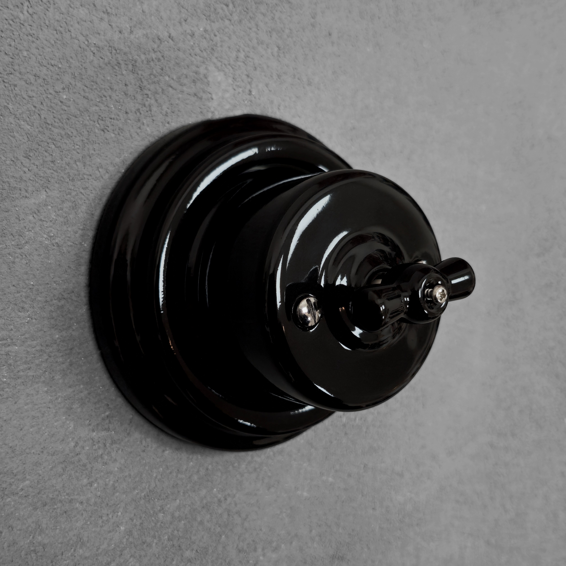 black porcelain intermediate rotary light switch, surface-mount, angled
