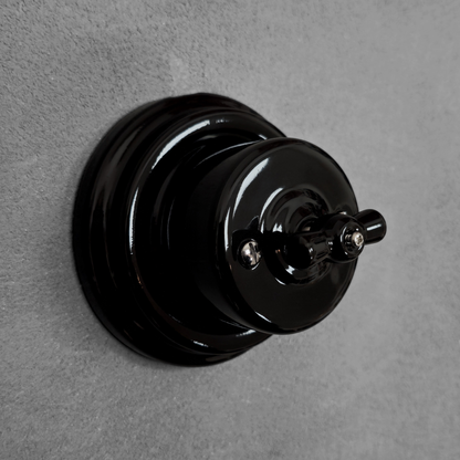 black porcelain intermediate rotary light switch, surface-mount, angled