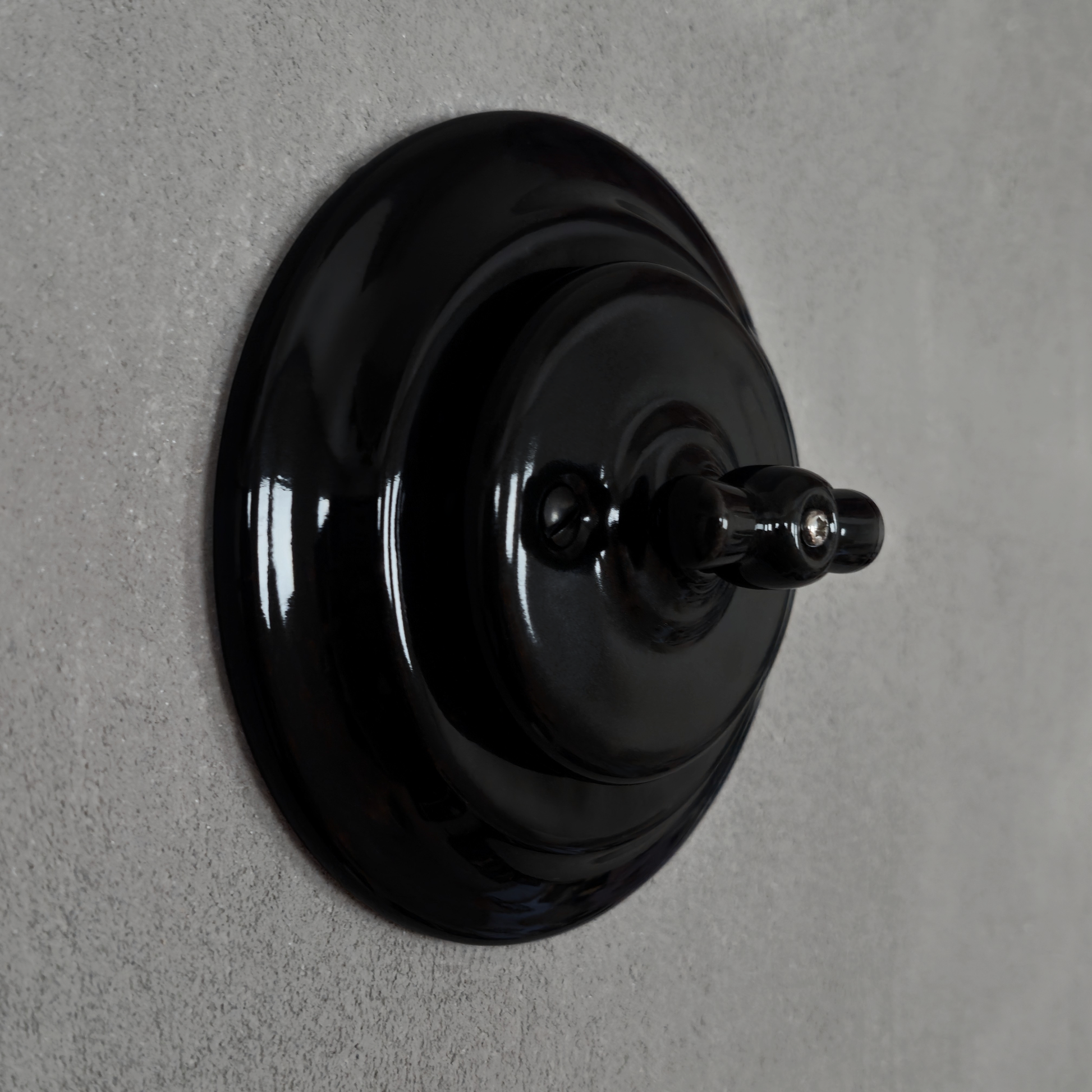 black porcelain intermediate rotary light switch, flush-mount, angled