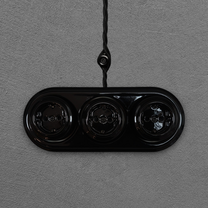 Triple SCHUKO porcelain socket, black, surface-mounted, front view