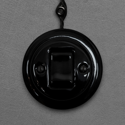 black porcelain intermediate big key light switch, surface-mount, front