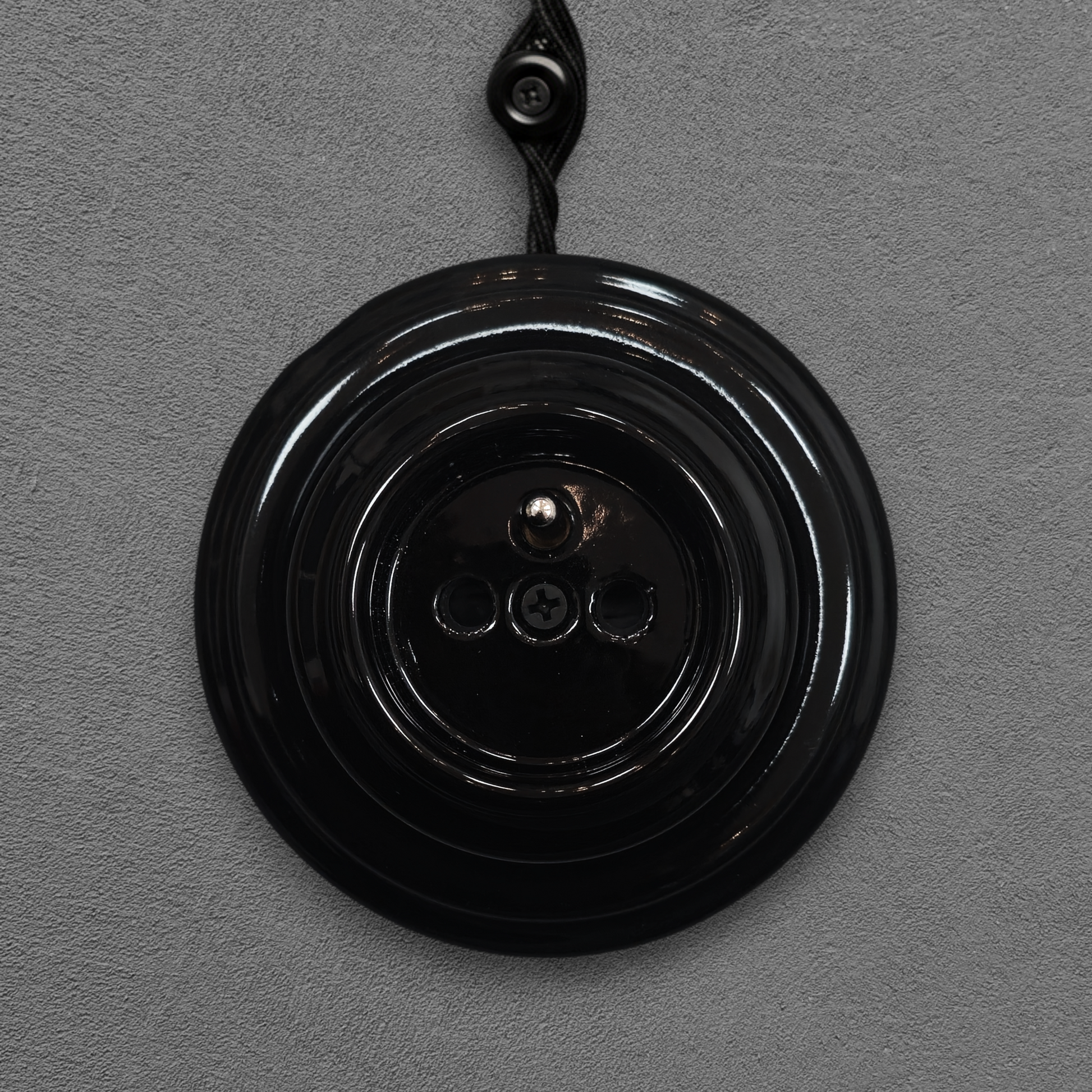 Single black French porcelain socket, surface-mount, front