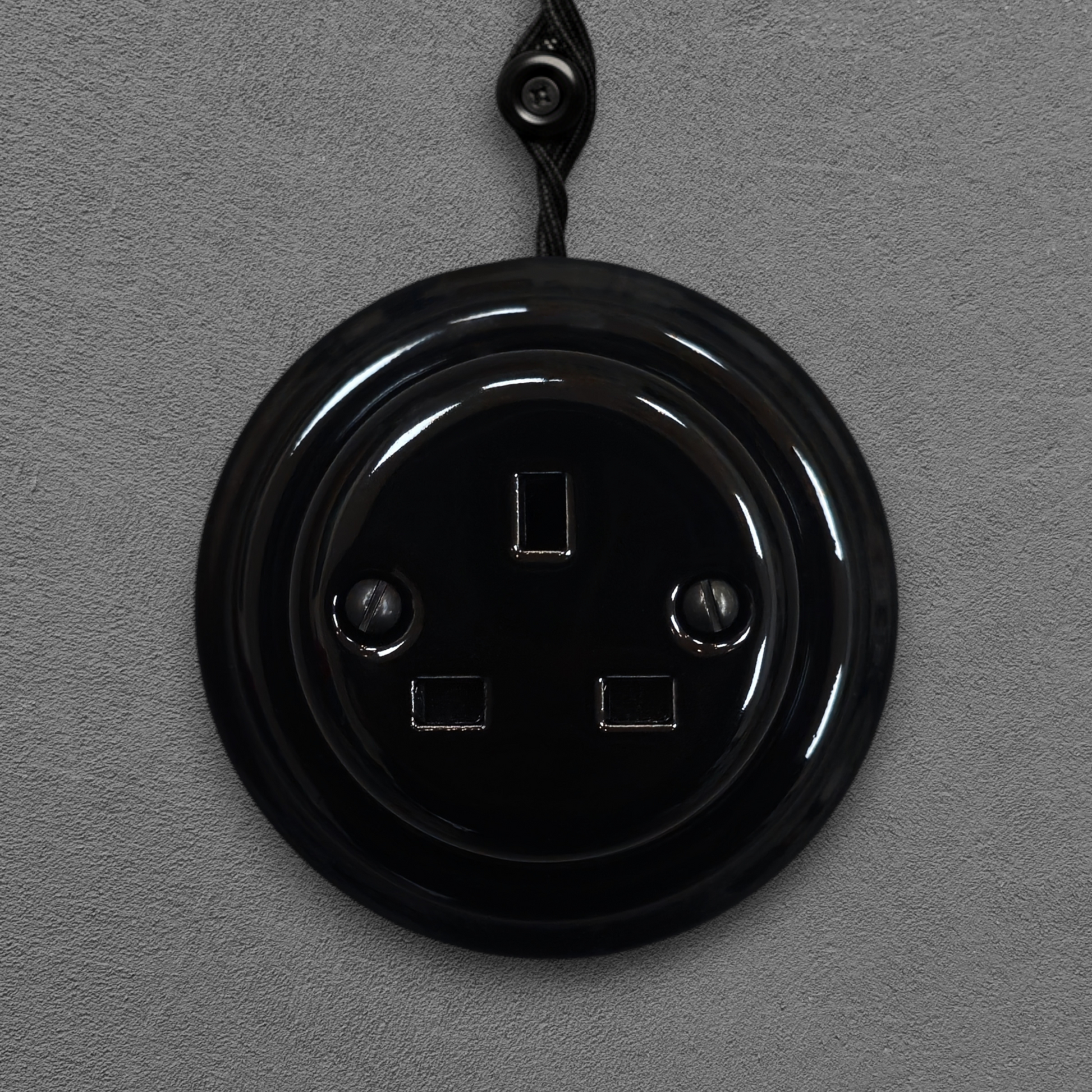 Black porcelain UK Plug Socket, surface-mounted, front
