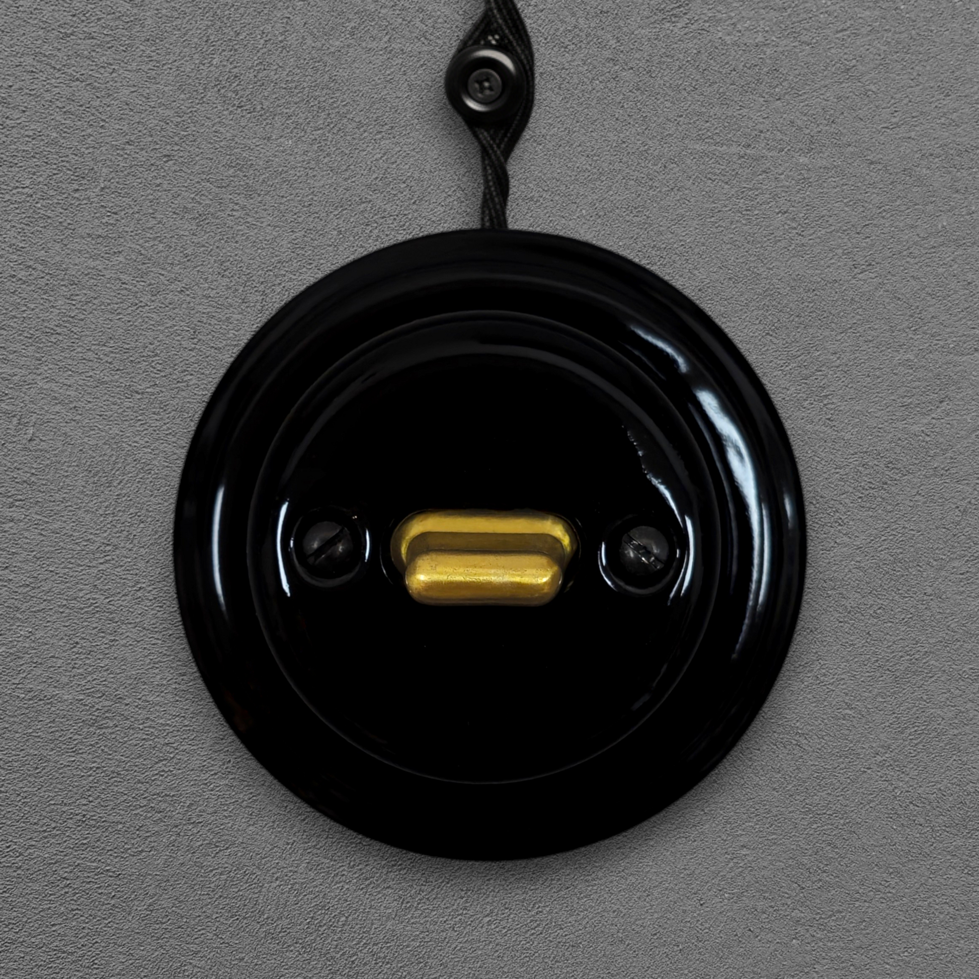 black porcelain intermediate toggle switch, surface-mount, front