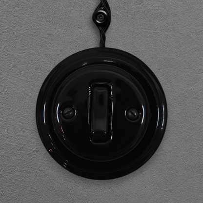 black porcelain 1gang2way light switch, surface-mount, front