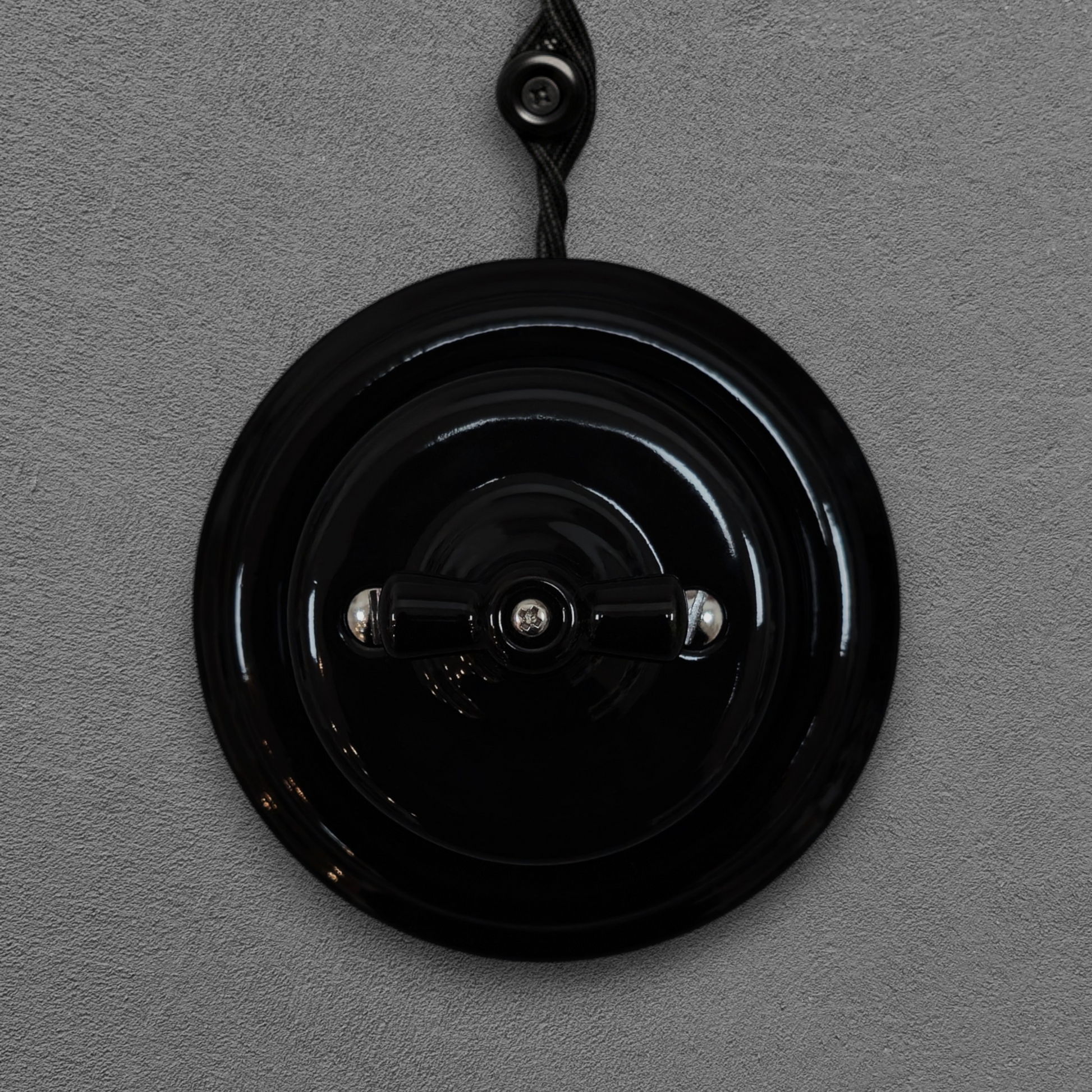 black porcelain intermediate rotary light switch, surface-mount, front