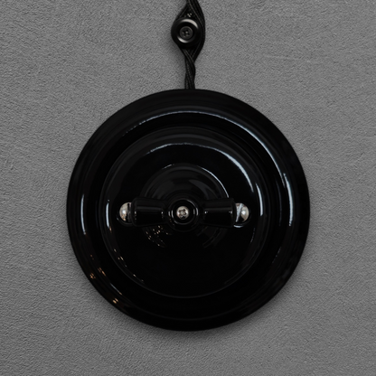 black porcelain 1gang2way rotary light switch, surface-mount, front