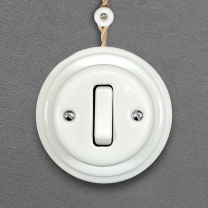 white porcelain 1gang2way light switch, surface-mount, front