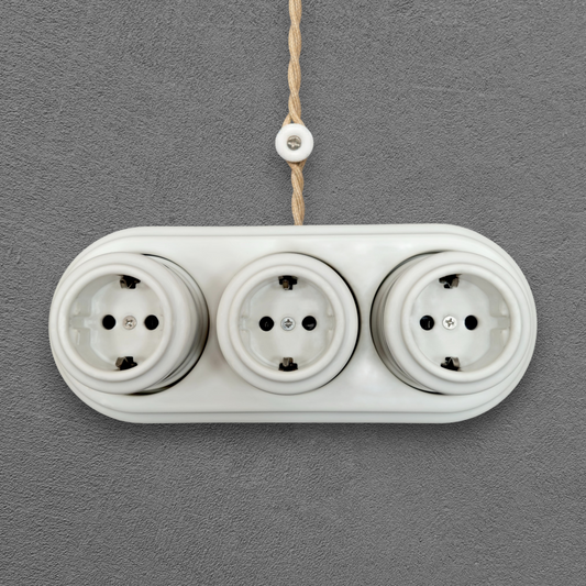 Triple SCHUKO porcelain socket, white, surface-mounted, front view