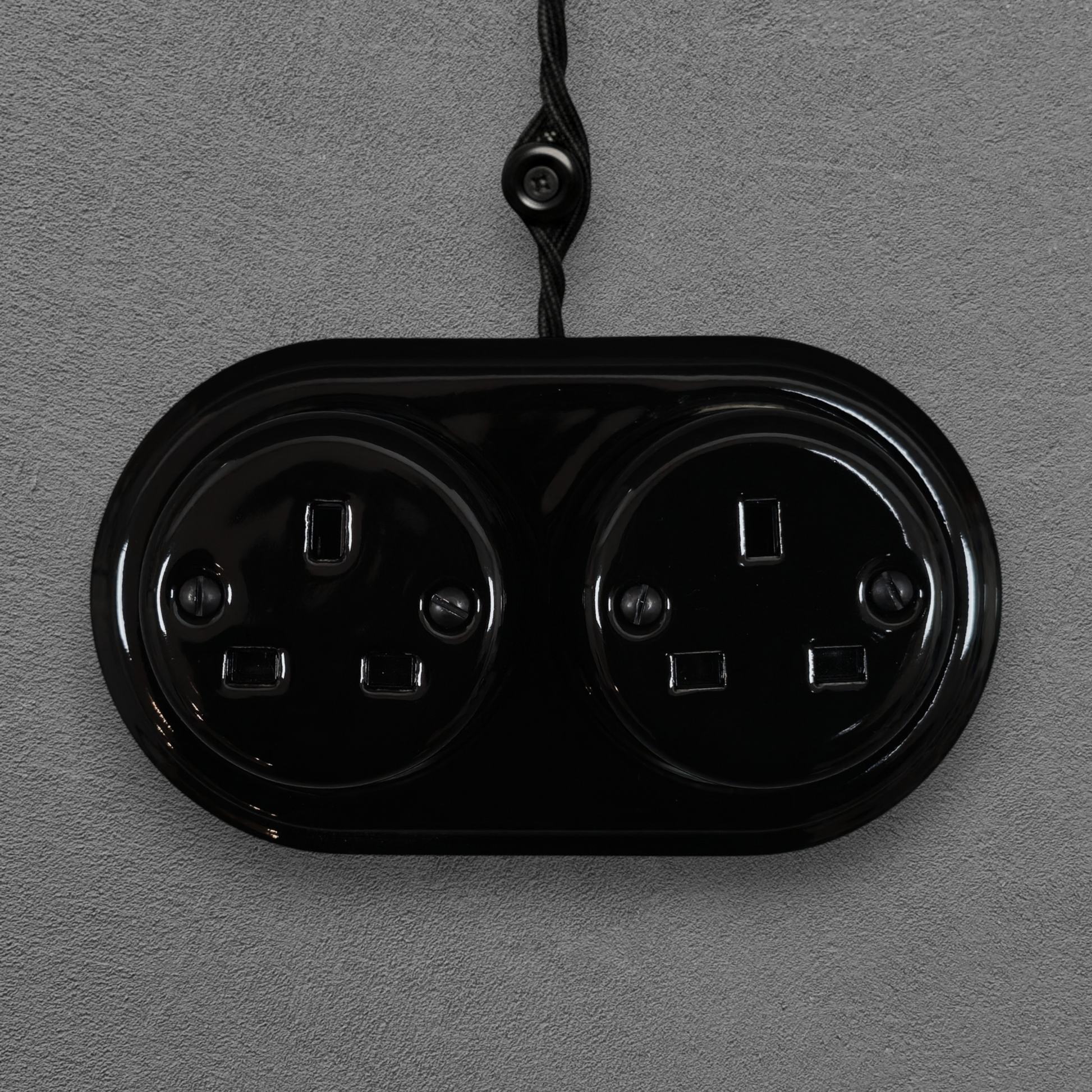 Double black porcelain UK Plug Socket, surface-mounted, front