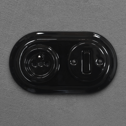 Black porcelain Type F socket with light switch, flush-mount, front