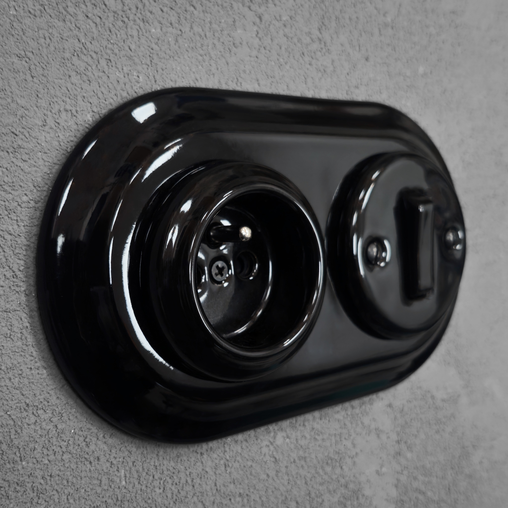 Black porcelain Type F socket with light switch, flush-mount, side