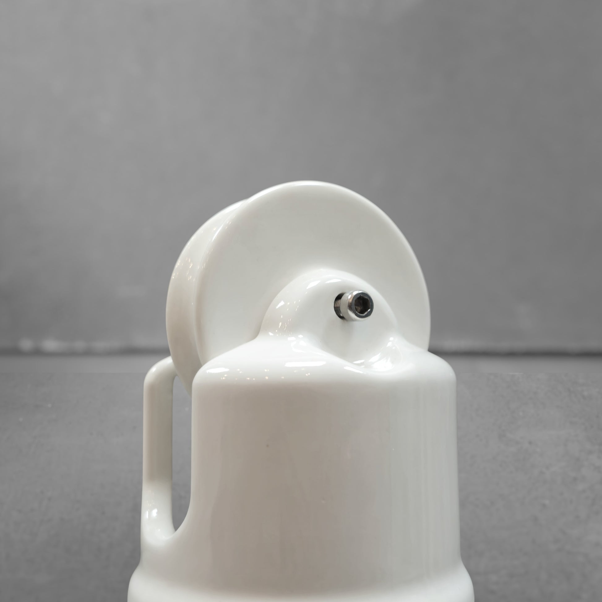 white porcelain counterweight for light fixture, close-up