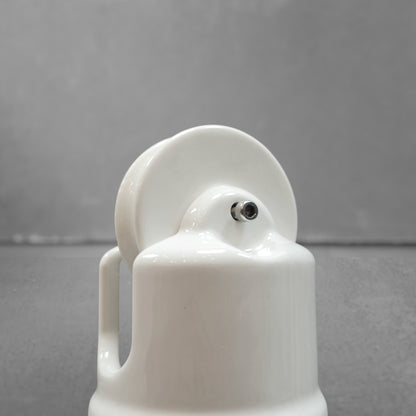 white porcelain counterweight for light fixture, close-up