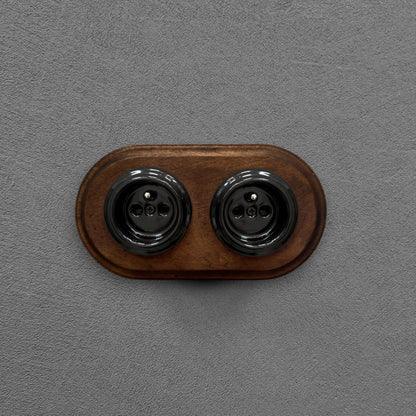 Double black French porcelain socket with dark wood frame, flush-mount
