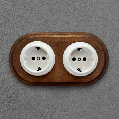 Double SCHUKO porcelain socket with dark wooden frame, white, flush-mounted, front view