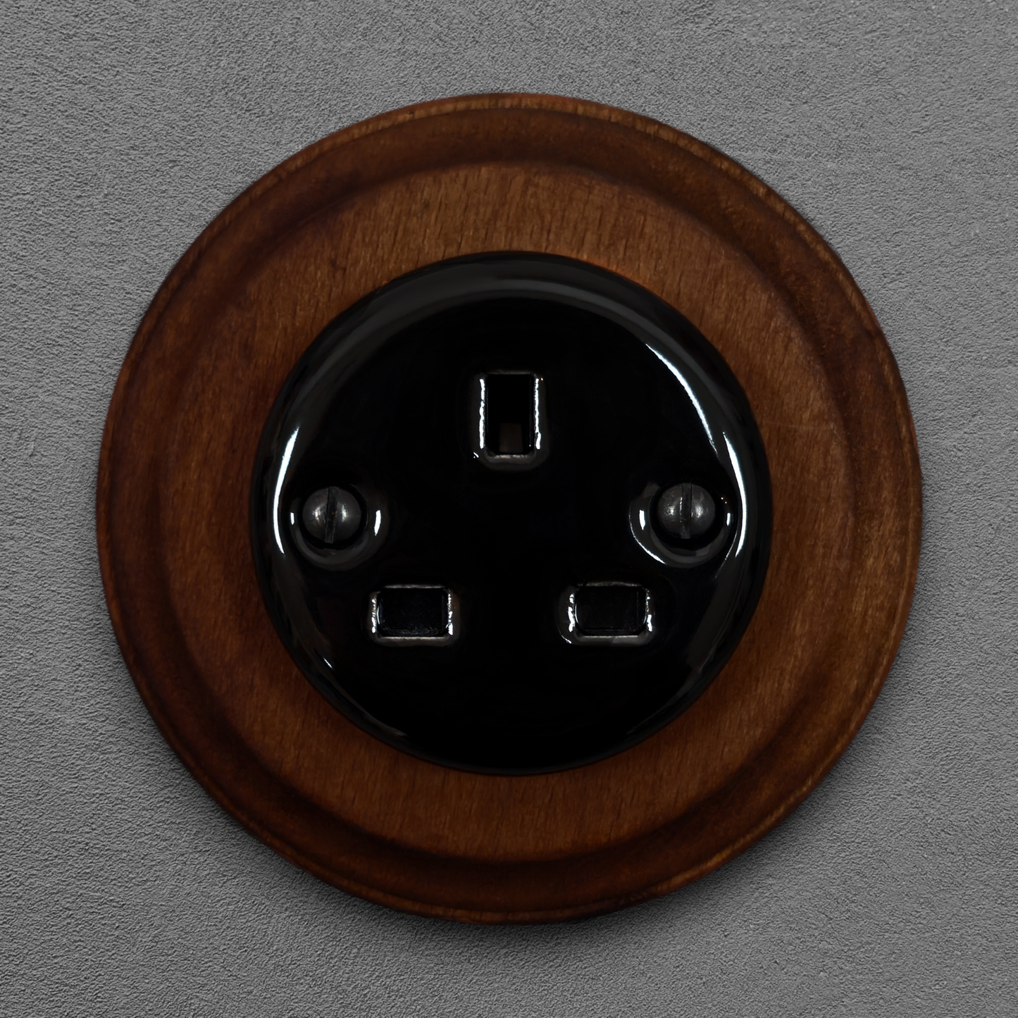 Black porcelain UK Plug Socket with dark wood frame, flush-mounted, front