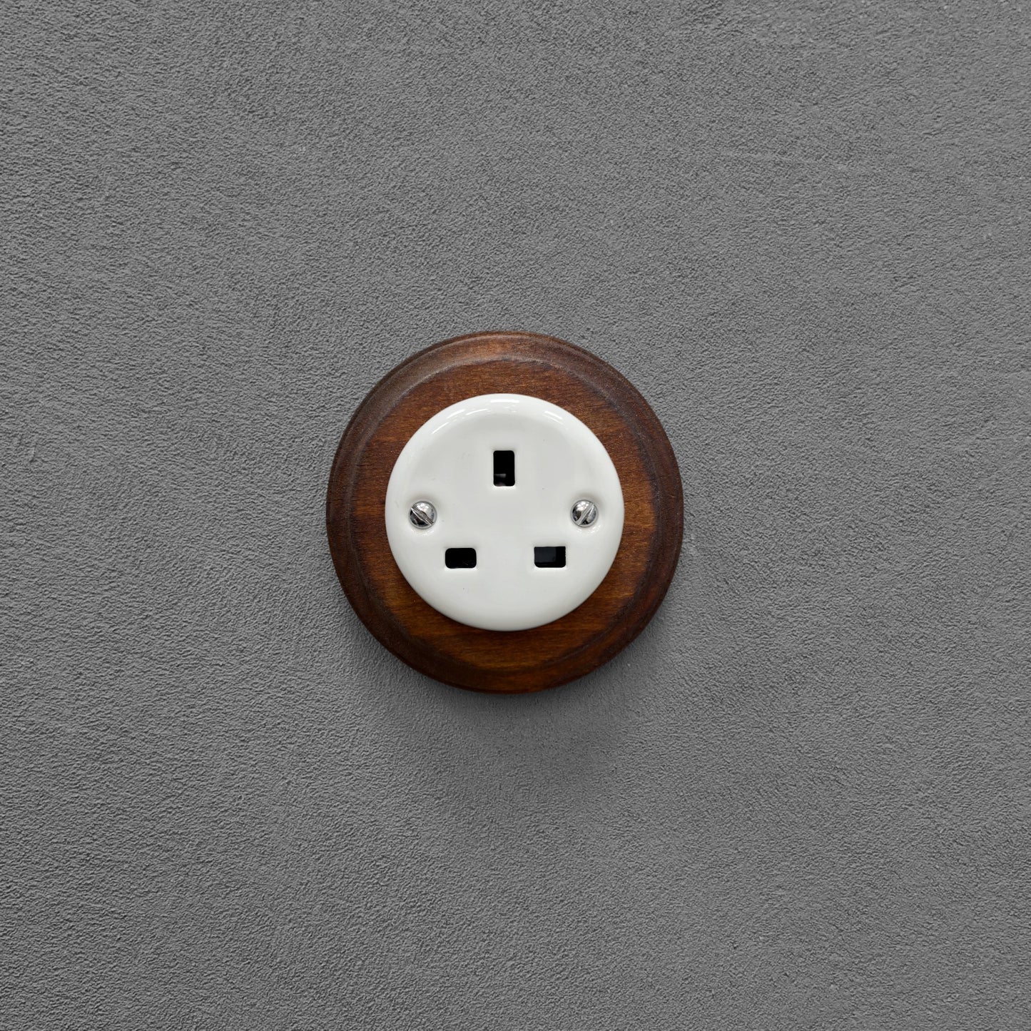 White porcelain UK Plug Socket with dark wood frame, flush-mounted
