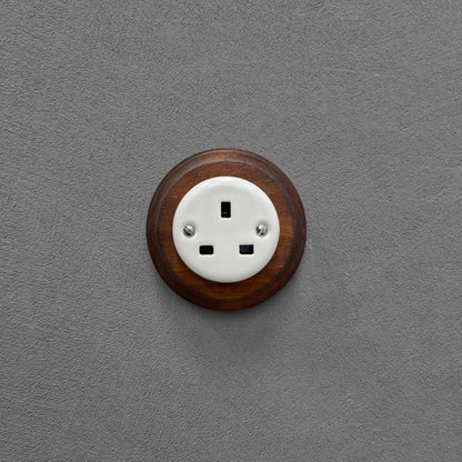White porcelain UK Plug Socket with dark wood frame, flush-mounted