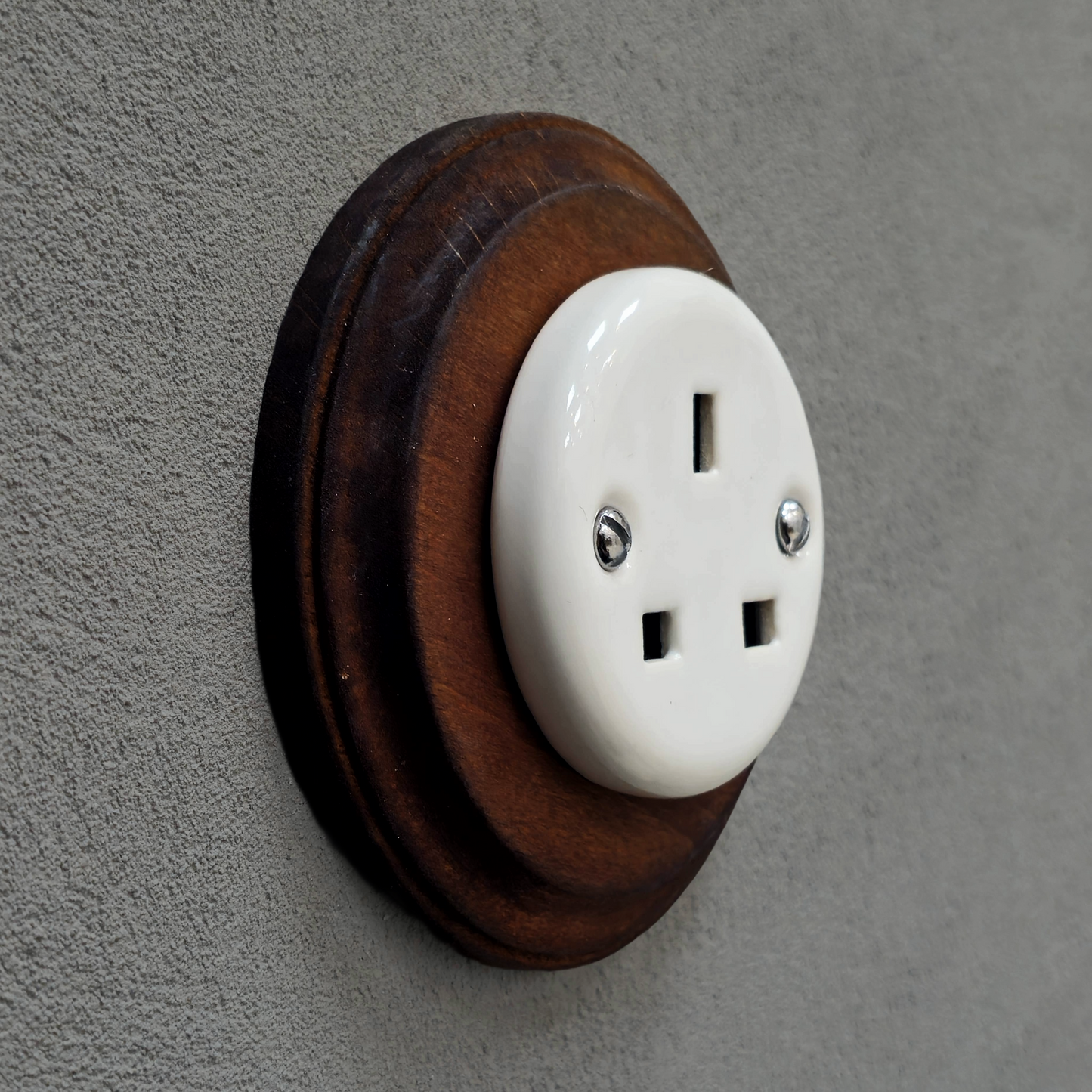 White porcelain UK Plug Socket with dark wood frame, flush-mounted, side