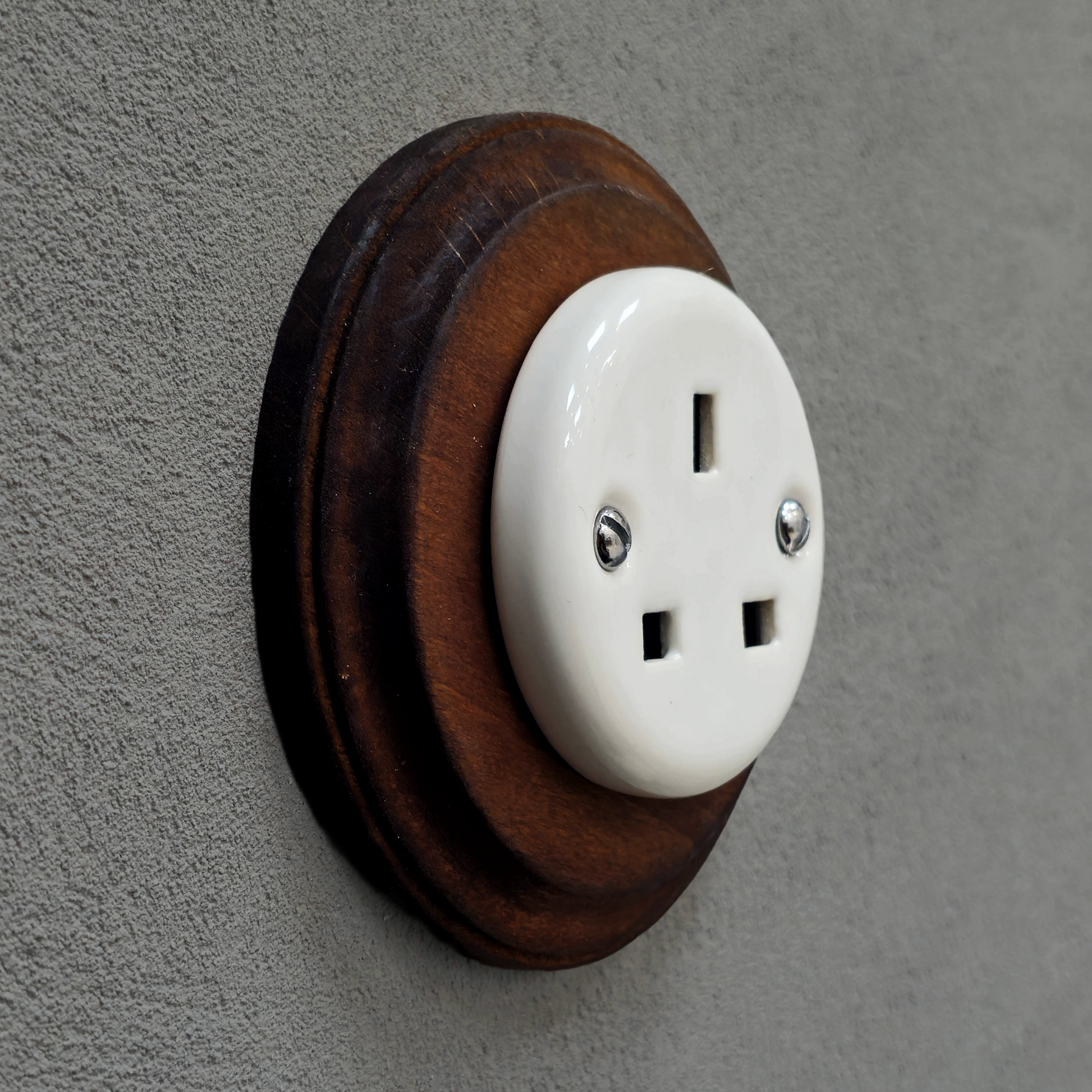 White porcelain UK Plug Socket with dark wood frame, flush-mounted, side
