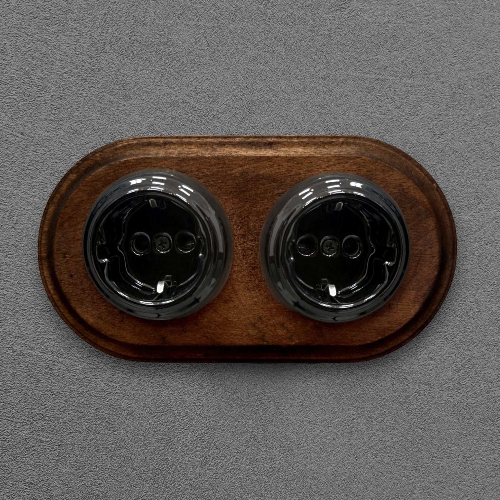 Double SCHUKO porcelain socket with dark wooden frame, black, flush-mounted, front view