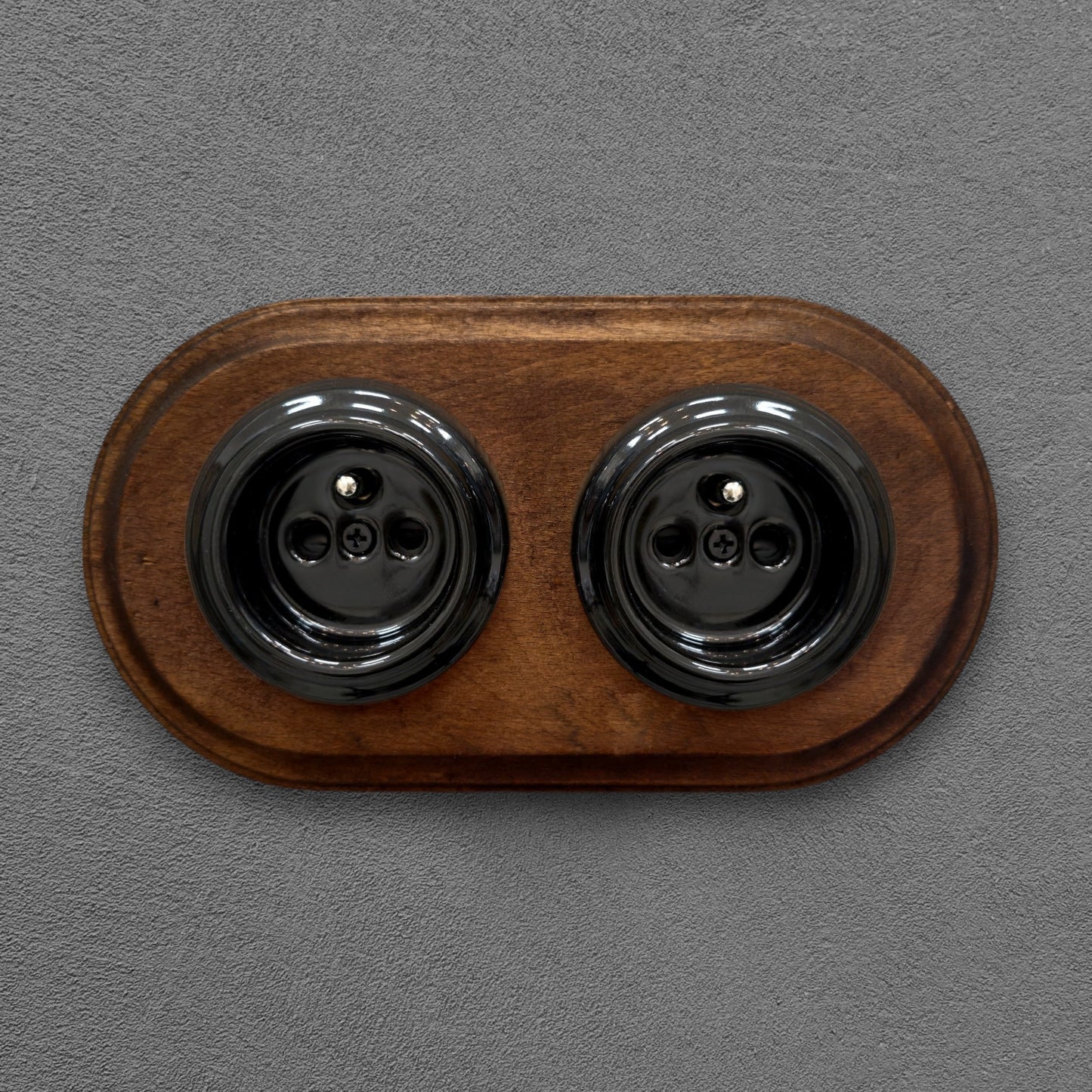 Double black French porcelain socket with dark wood frame, flush-mount, front
