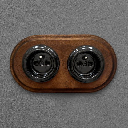 Double black French porcelain socket with dark wood frame, flush-mount, front