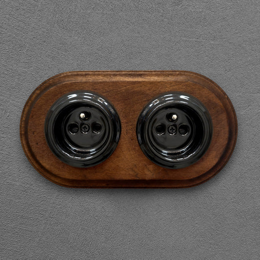 Double black French porcelain socket with dark wood frame, flush-mount, front