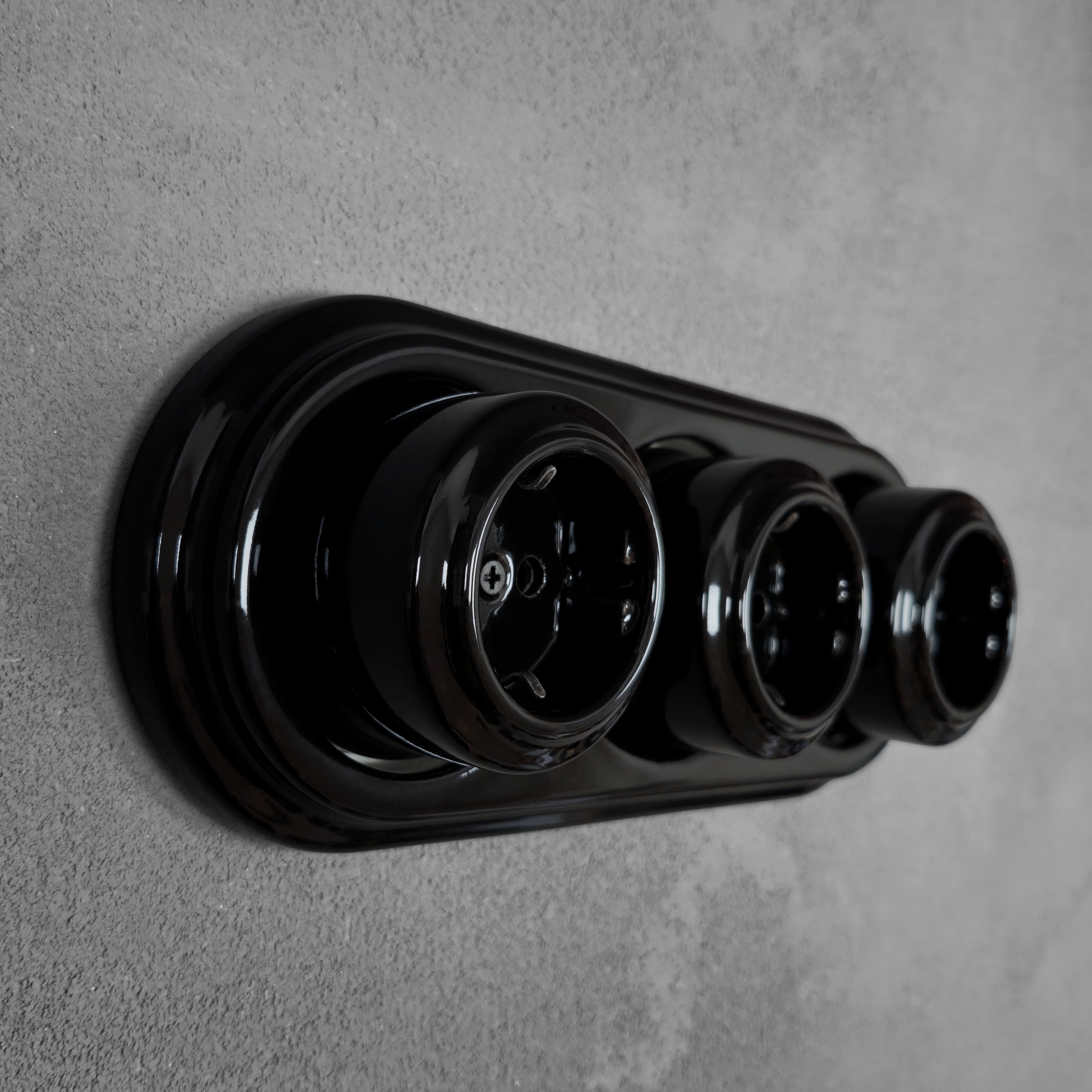 Triple SCHUKO porcelain socket, black, surface-mounted, side view