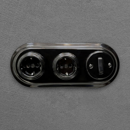 Double SCHUKO porcelain socket with light switch, black, flush-mounted, front view
